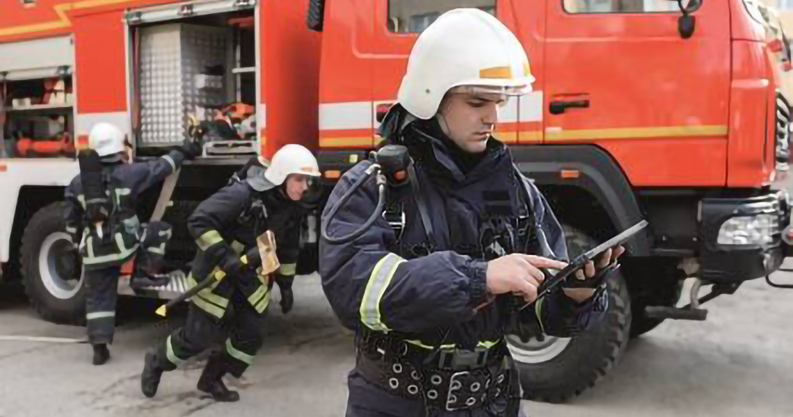 Firefighters at a scene unpacking gear from the firetruck and running